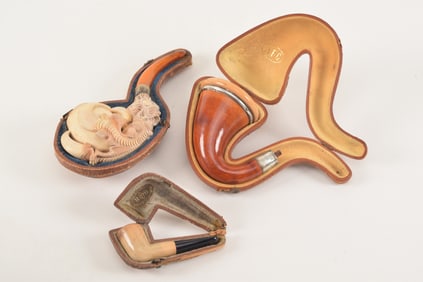 3 Pipes including a carved Meerschaum in the form of a dragons claw. Used condition, each cased.