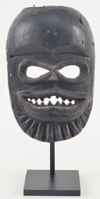 Early 20th century African Ibibio carved wood mask. Museum mount. Mask 10 x 6.5in. Overall: 14in.