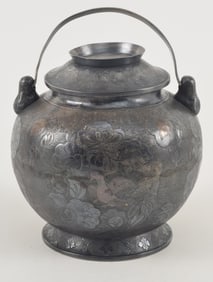 Silver handled covered jar. China. Tang period. Globular form. Surface engraved with lotus flowers