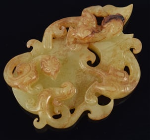 Jade pendant. China. Han period (2nd century BC to 2nd century AD). Yellow stone with brown marking