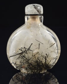 Rutilated quartz snuff bottle. China. Ca. 1850. Pear shaped. Well hollowed. Fissures to the foot.