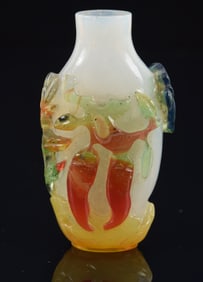 Overlay snuff bottle. China. Ca. 1850. Su Chou school 5-color work. Decoration of flowers and chili