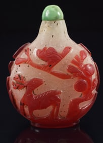 Cameo glass snuff bottle. China. Ca. 1850. Red cut to snowflake. Design of a crane in a landscape.