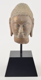 Carved stone head of the buddha. China. Northern Dynasties type. Surface with gilt traces. 10in.