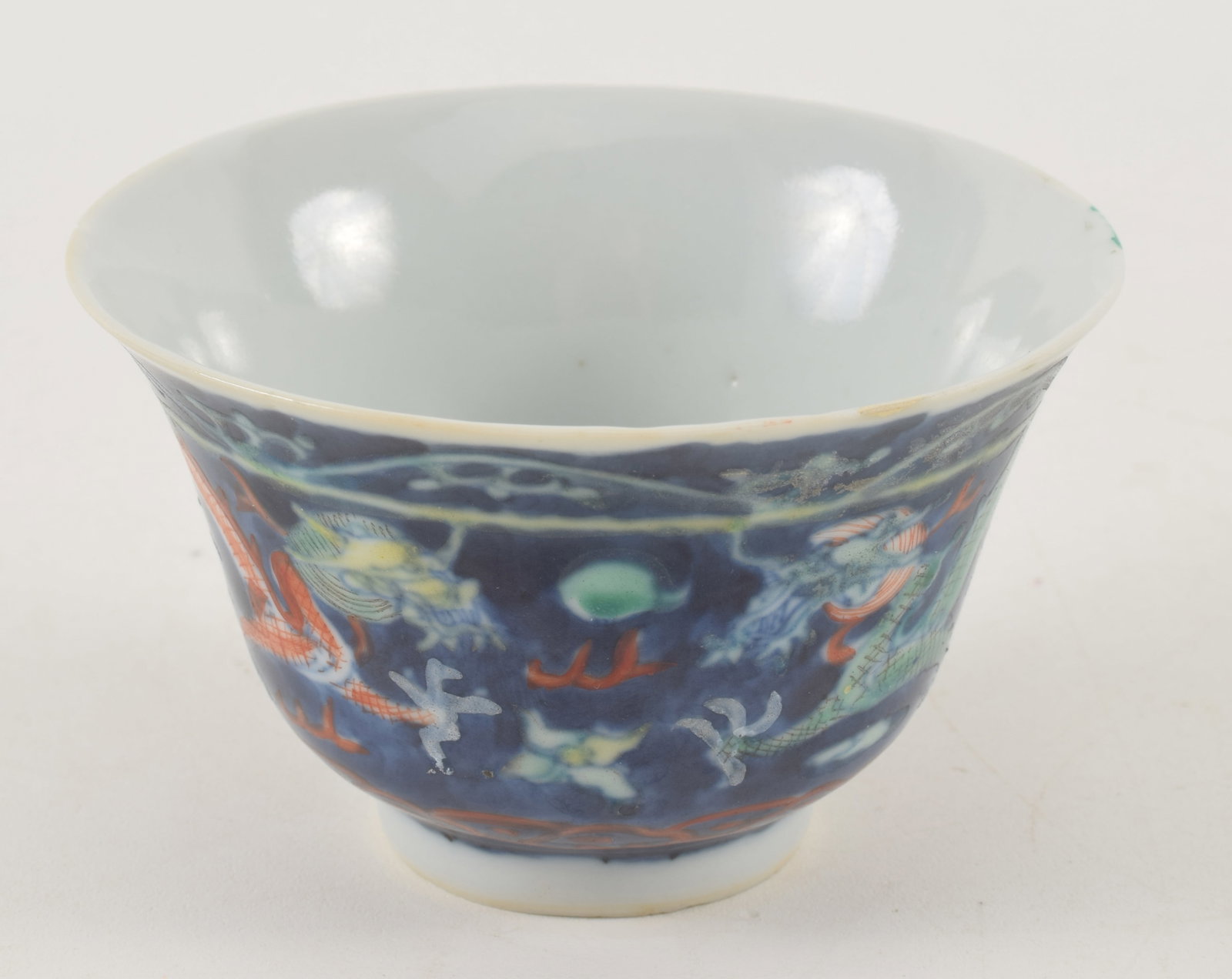 Porcelain cup. China. 19th century. Tou Tsai ware. Decoration of dragons. Kang Hsi mark. Small chip.: Porcelain cup. China. 19th century. Tou Tsai ware. Decoration of dragons. Kang Hsi mark. Small chip. 3.5 x 2.25in.