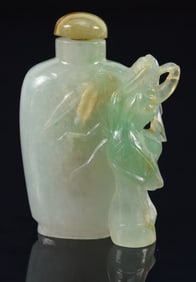 Jadeite snuff bottle. China. Surface carved with a flower. 1.25in.