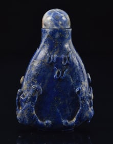 Lapis lazuli snuff bottle. China. Early 20th century. Pear shaped with chih lung carvings. Matching