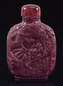 Ruby snuff bottle. China. Early 20th century. Carved with dragons. Well hollowed. 2.25in.