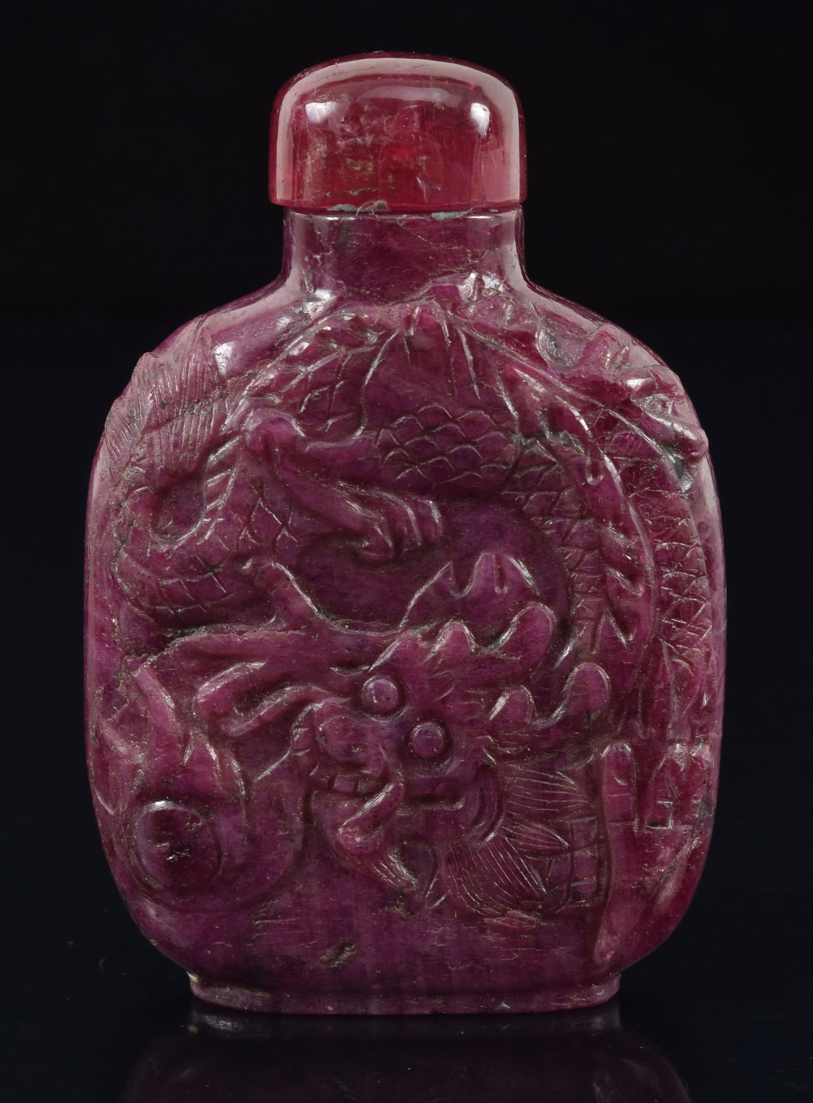 Ruby snuff bottle. China. Early 20th century. Carved with dragons. Well hollowed. 2.25in.: Ruby snuff bottle. China. Early 20th century. Carved with dragons. Well hollowed. 2.25in.