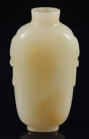 Jade snuff bottle. China. 19th century. White stone with a yellow marking. Well hollowed. 2.5in.