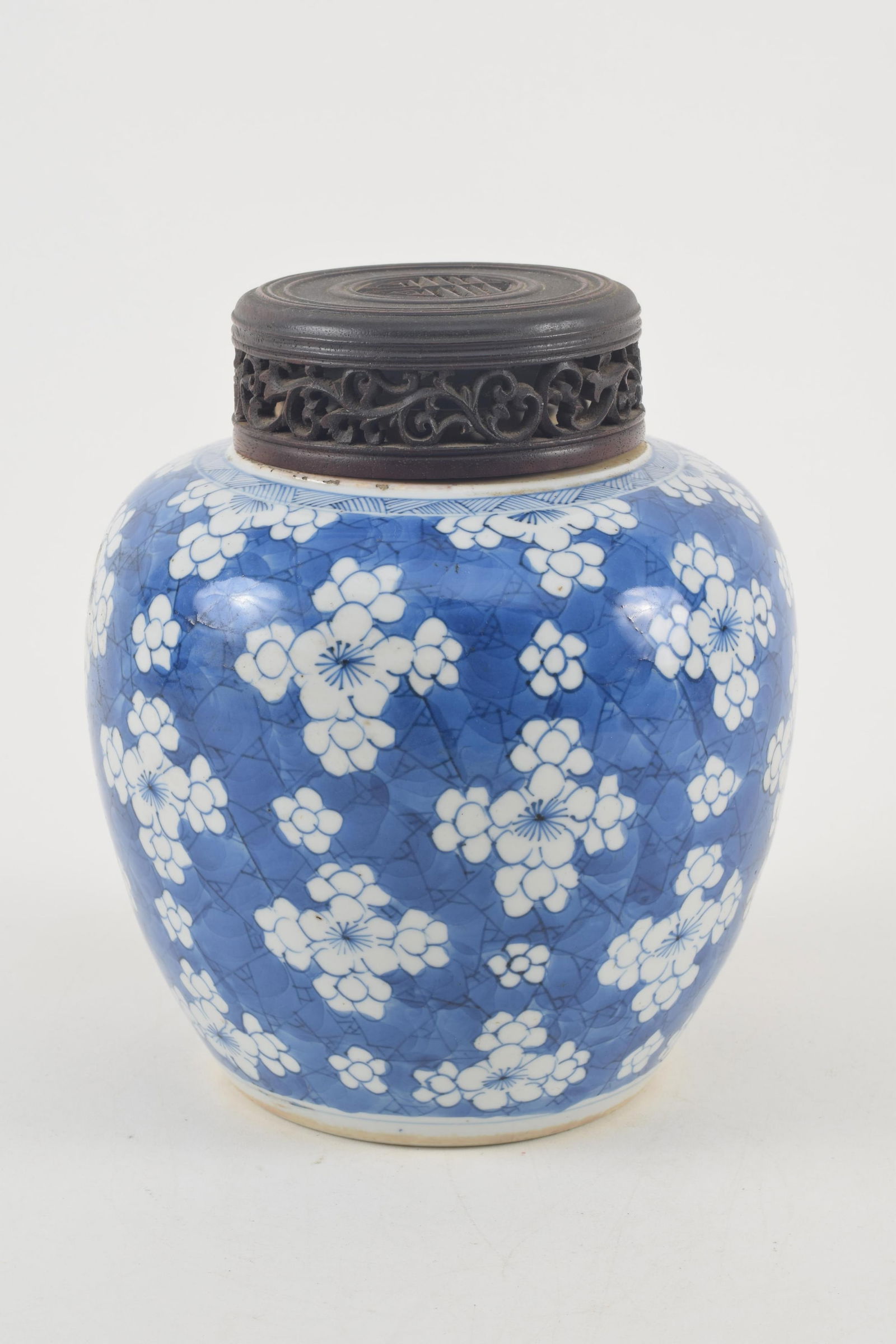 Porcelain covered jar. China. Kang Hsi period (1662-1722). Underglaze blue prunus decoration. 6.5in.: Porcelain covered jar. China. Kang Hsi period (1662-1722). Underglaze blue prunus decoration. Cover damaged with losses. Old crack in body of vase. 6.5in.