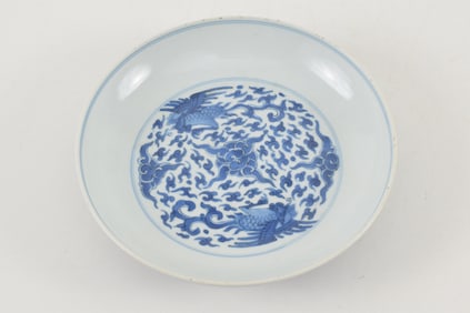 Porcelain saucer. China. 18th century. Underglaze blue decoration of phoenixes and clouds. Cheng Hua