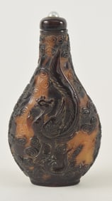 Shell snuff bottle. China. Ca. 1850. Pear shaped. Surface carved with dragons, phoenixes and clouds.