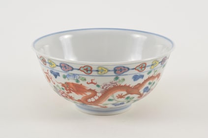 Porcelain bowl. China. Tao Kuang mark. Decoration of dragons, phoenixes and clouds. 6.25in diameter.