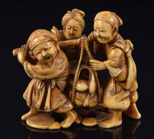 Netsuke of farmers hauling a heavy load of vegetables. Japan. 19th century. 1.75 x 2in.