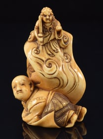 Netsuke of 2 children playing with a scroll which animates the drawing of Myo Oi. Signed. 2in.