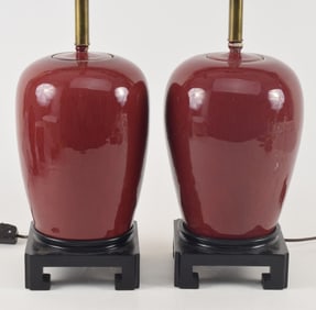 Pair of oxblood covered jars. China. Early 20th century. Ovoid form. Drilled and mounted as lamps.