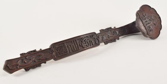 Carved hardwood Ju-i. China. Early 20th century. Surface carved with auspicious designs. 20in.
