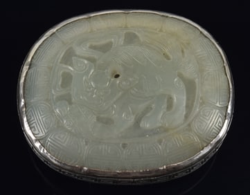 Jade belt plaque. China. 17th century. Ming oval jade set in engraved silver. 2.5in.