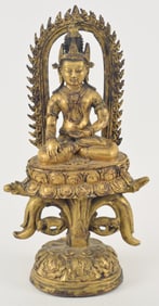 Gilt bronze buddha. Nepal. 20th century. Seated figure on an ornate lotus throne. 18 x 9.5in.