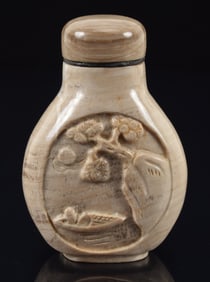 Hardstone snuff bottle. China. Ca. 1900. Tan striated stone carved with a scene of a man in a boat