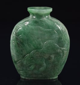 Jadeite snuff bottle. China. Ca. 1900. Bright green stone carved with a tiger and flowers. 2.25in.