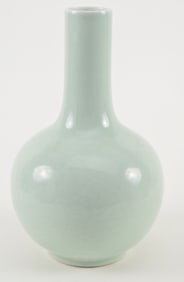 Porcelain bottle vase. China. 19th/early 20th century. Carved floral scrolling beneath a pale