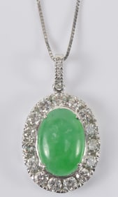 Jadeite pendant. Emerald green color, highly translucent. Set in 14K white gold with diamonds. GIA