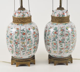 Pair of porcelain covered jars. China. 19th century. Famille verte decoration of columns of birds