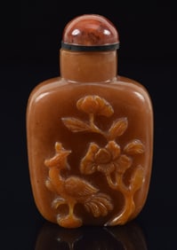 Agate snuff bottle. China. Ca. 1900. Surface carved with a phoenix and peony. 2.25in.