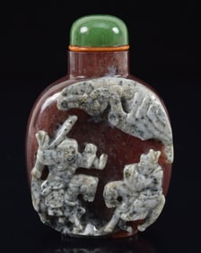 Agate snuff bottle. China. Ca. 1850. Mauve colored stone with the white and grey skin carved with an