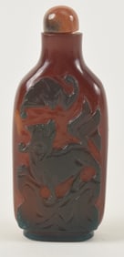 Cameo glass snuff bottle. China. Ca. 1900. Dark green cut to brick red with a tiger. 2.5in.