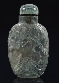 Beryl snuff bottle. China. Ca. 1850. Grey, blue highly transparent stone carved with dragons and a