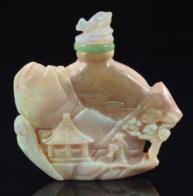 Opal snuff bottle. Surface carved as a landscape with pavilions. 2 x 2.5in.