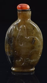 Smoky quartz snuff bottle. China. Ca. 1900. Surface carved with a hare. Well hollowed. 2.25in.