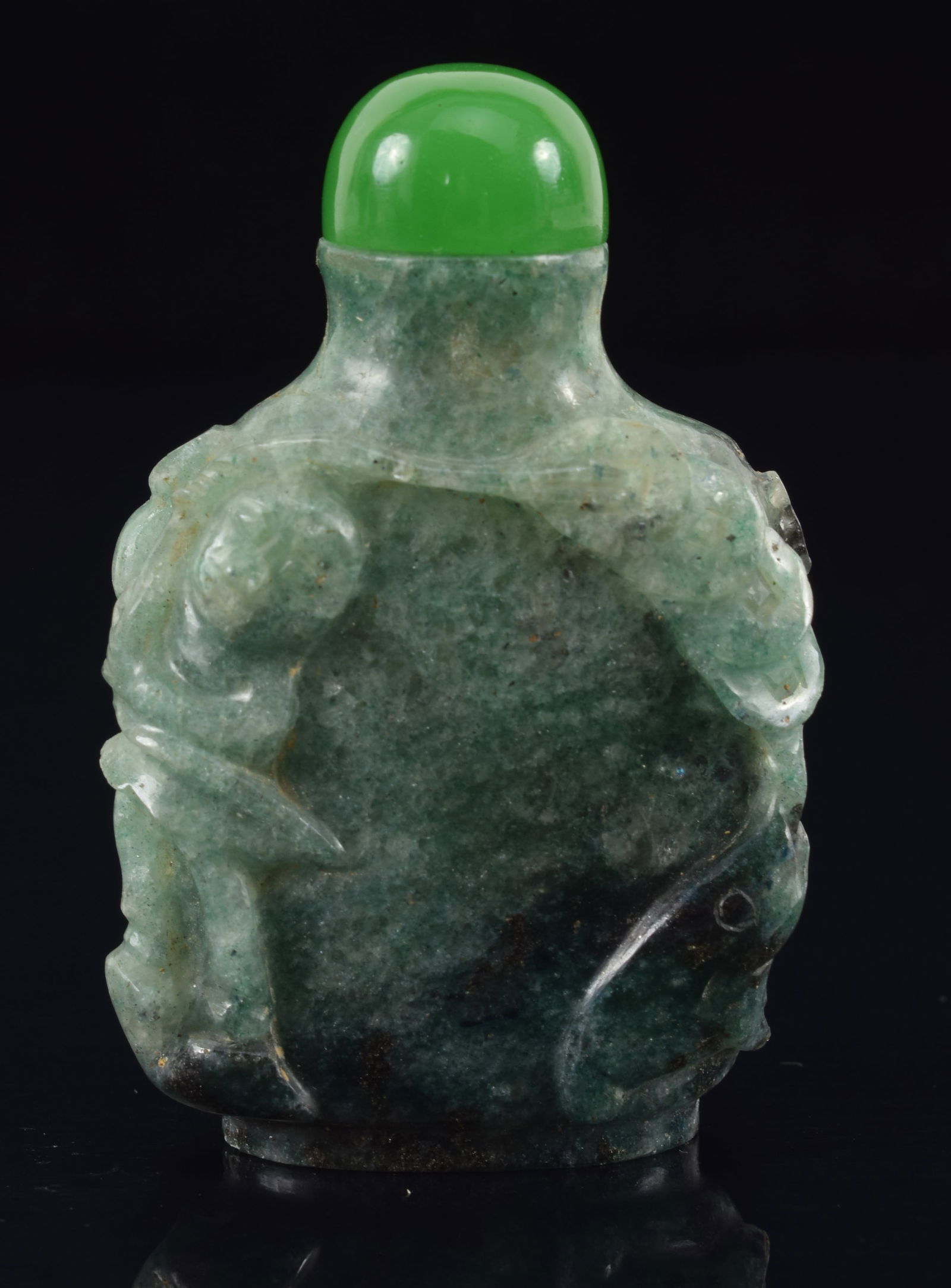Jade snuff bottle. China. Surface carved with flowers. 2.5in.: Jade snuff bottle. China. Surface carved with flowers. 2.5in.