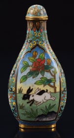 Cloisonne snuff bottle. China. Ca. 1900. Decoration of rabbits under maple trees. Stylized floral