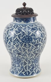 Baluster jar. China. 19th century. Underglaze blue floral decoration. Wooden cover. 15in.
