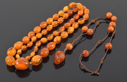 2 strands of amber beads. Largest bead on graduated necklace: 22 x 26.8mm. 19.6 grams and 78.6 grams