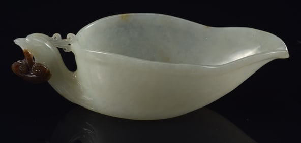 Jade cup. China. 19th century. Archaic kuang shape with a phoenix handle. Highly translucent stone