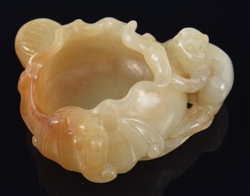 Jade water coupe. China. 19th century. Pale tan stone with brown markings. Carved as a lotus pad