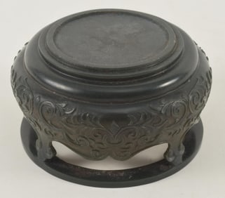 Spinach green jade stand. China. 19th century. Surface carved with lotus scrolling. 4 x 2.5in.