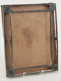 Picture frame. China. Early 20th century. Engraved silver set with four carved jade roundels. 12.25
