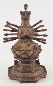 Carved wooden image of the goddess of infinite compassion. Seated figure of Kuan Yin on a lotus