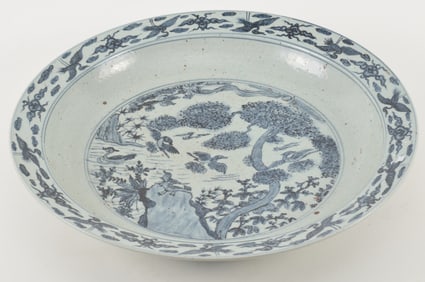 Large porcelain charger. China. Probably Ming period. Blue and white decoration of birds and