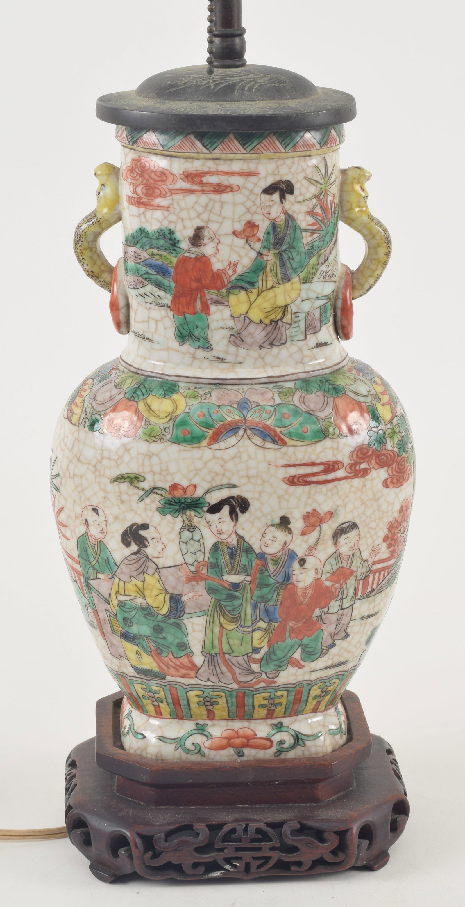 Porcelain vase. China. Early 20th century. Oatmeal ground with famille verte decoration of women and: Porcelain vase. China. Early 20th century. Oatmeal ground with famille verte decoration of women and children. Drilled and mounted as a lamp. Overall: 24in.
