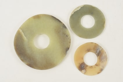 3 jade pi. Celadon colored stone. Largest 5in diameter.