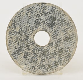 Jade bi. China. Han type. Surface decorated with grain patterns. Green stone, highly calcified. 7in.