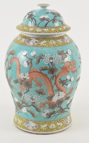Porcelain covered jar. China. Early 20th century. Turquoise ground with sepia and white dragons and