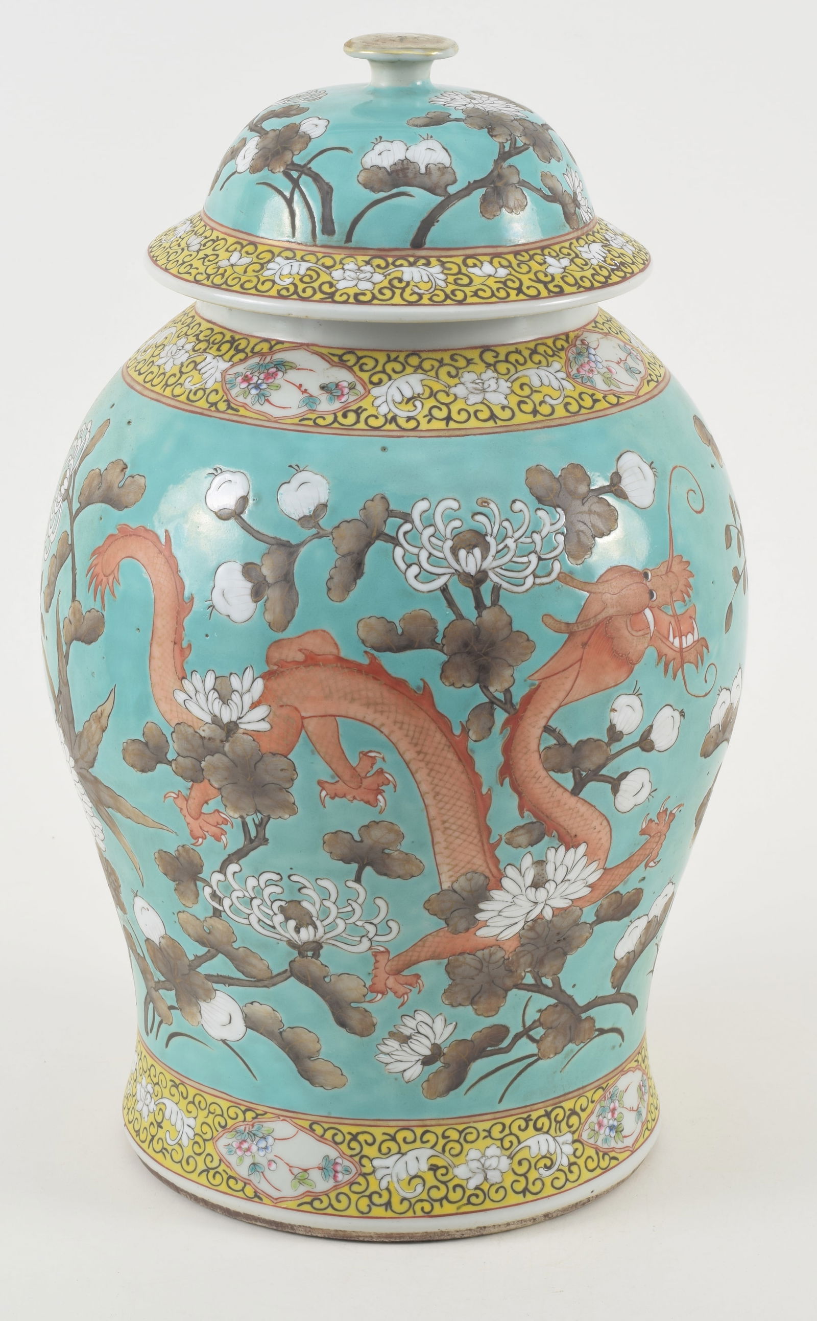 Porcelain covered jar. China. Early 20th century. Turquoise ground with sepia and white dragons and: Porcelain covered jar. China. Early 20th century. Turquoise ground with sepia and white dragons and flowers. Floral yellow borders. 16in.